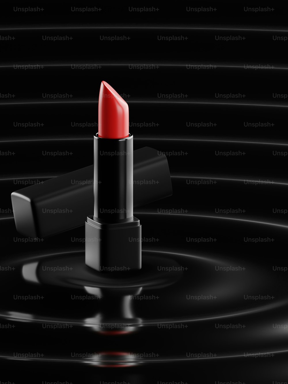 a red lipstick sitting on top of a black surface