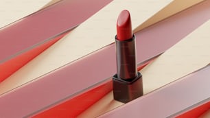 a red lipstick sitting on top of a table