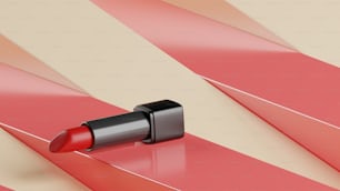 a close up of a red lipstick on a striped surface