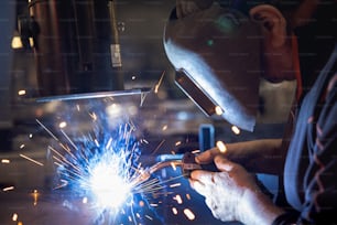 Un soldador trabajando en una pieza de metal