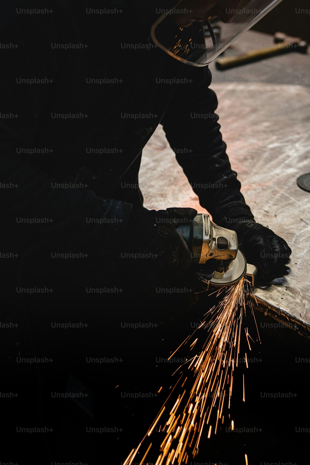 a person using a grinder on a piece of metal