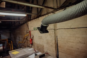 a pipe is hanging from the ceiling of a building