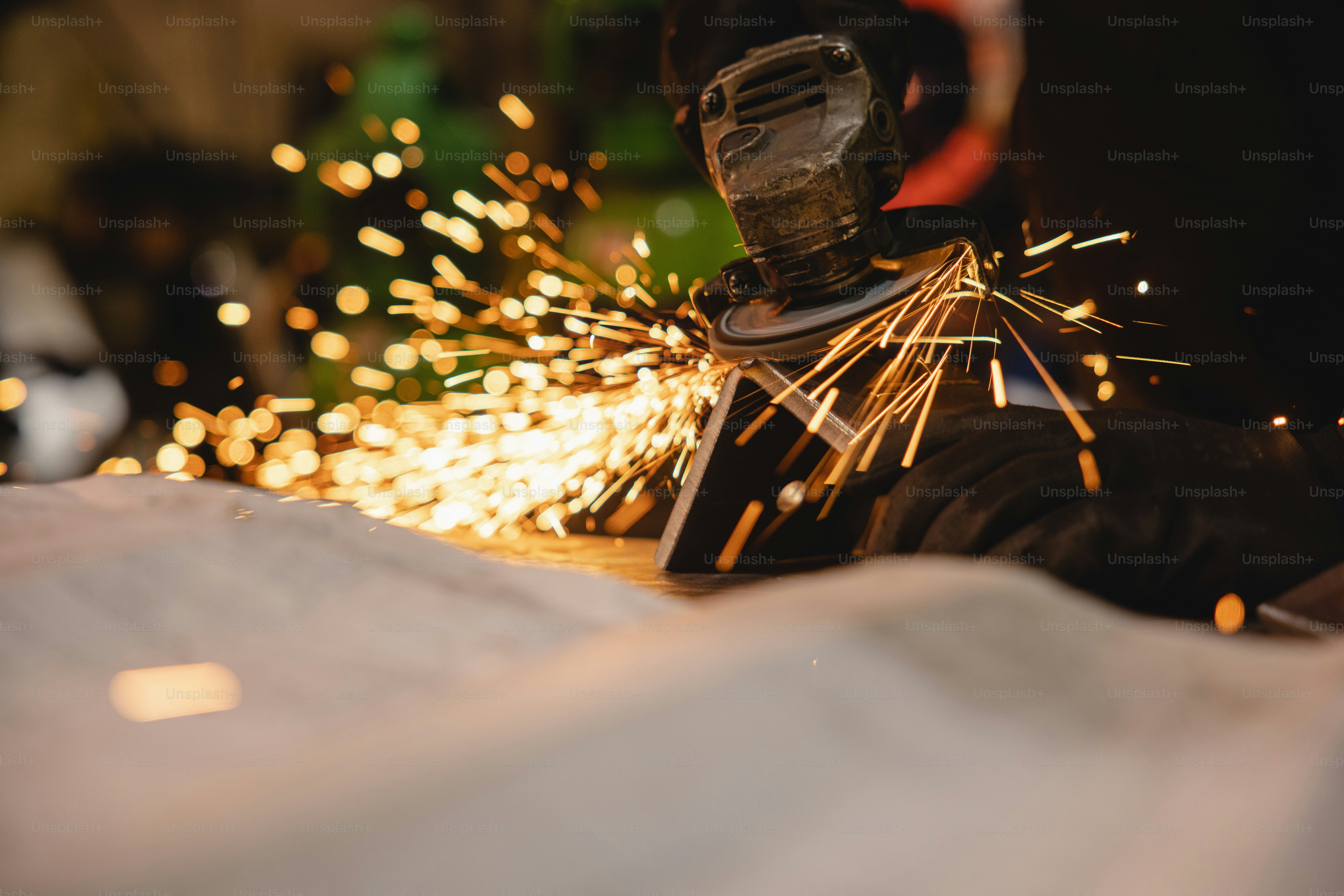 a person using a grinder on a piece of metal