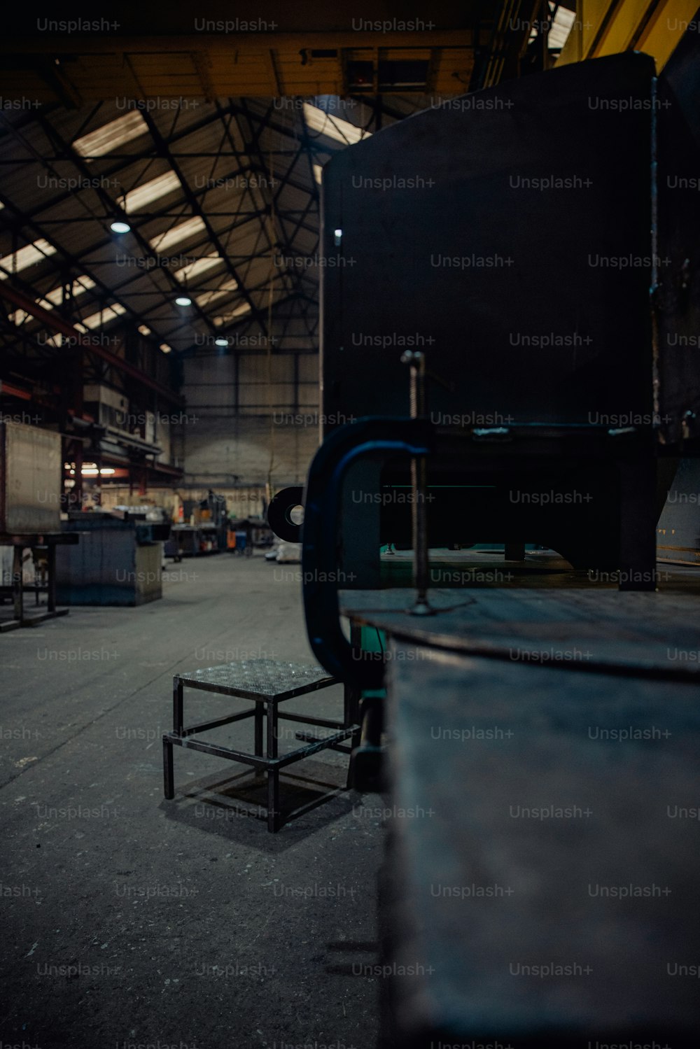 a large machine in a large building with lots of windows