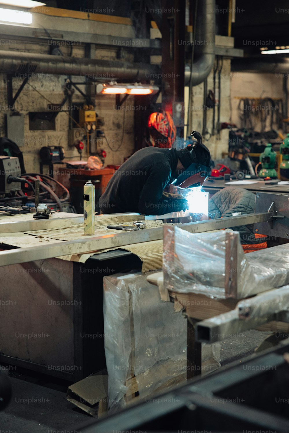 a man working on a piece of metal in a shop