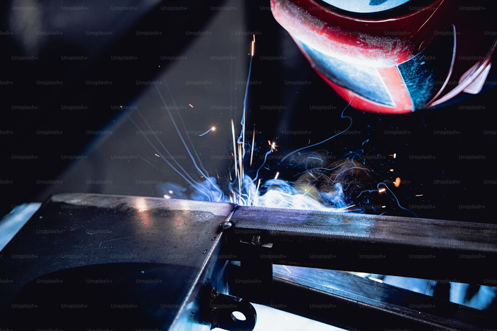 a welder cutting a piece of metal with a grinder