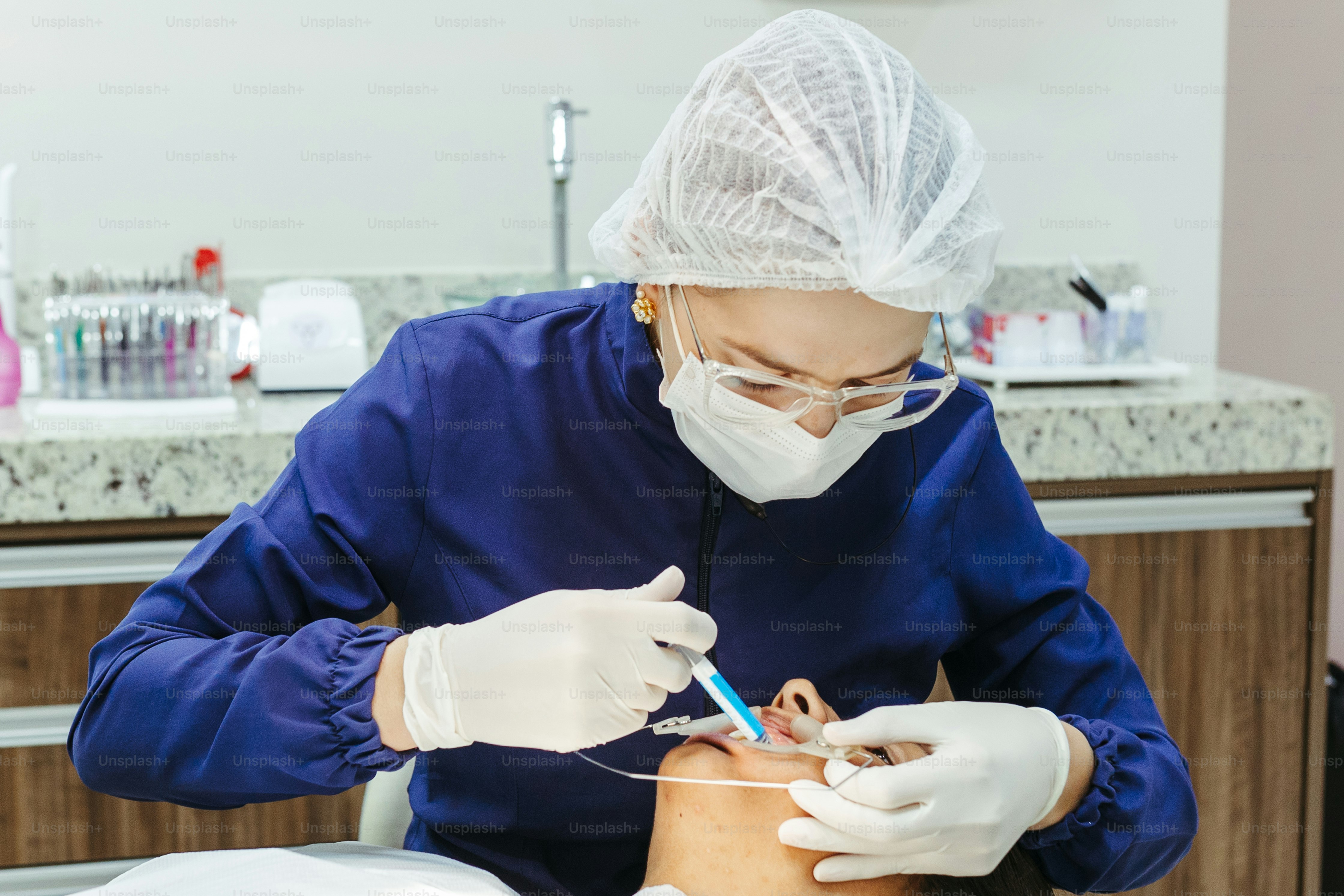 a woman getting her teeth checked by a dentist
