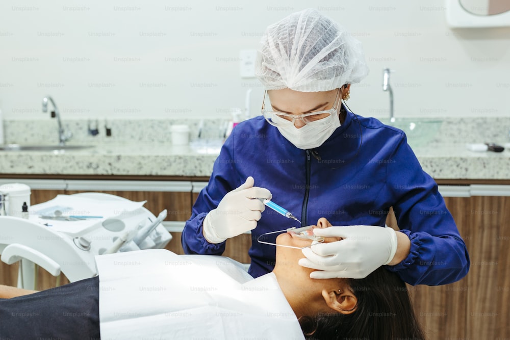 a woman getting her teeth checked by a dentist