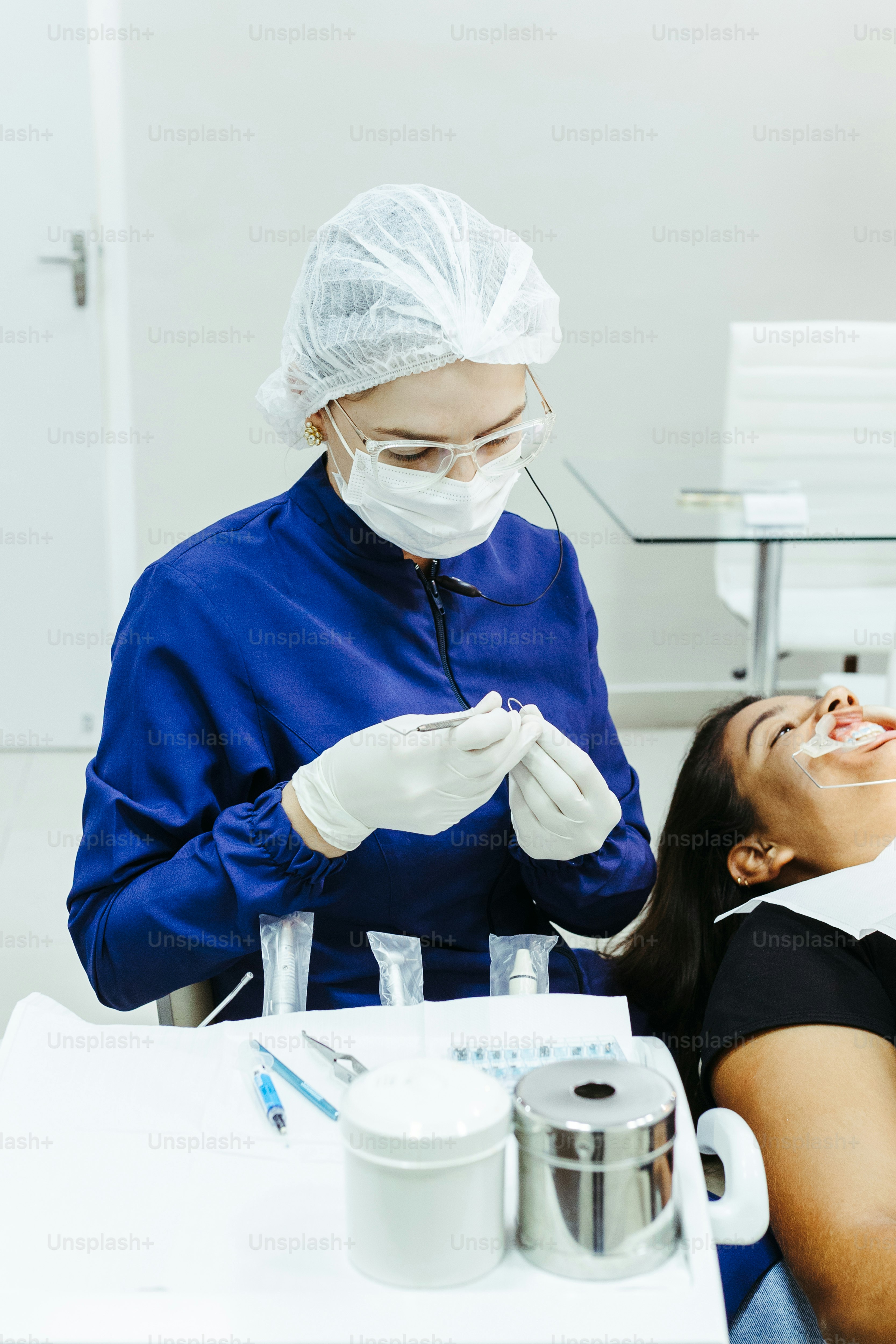 a woman getting her teeth checked by a dentist