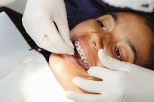 a woman getting her teeth checked by a dentist