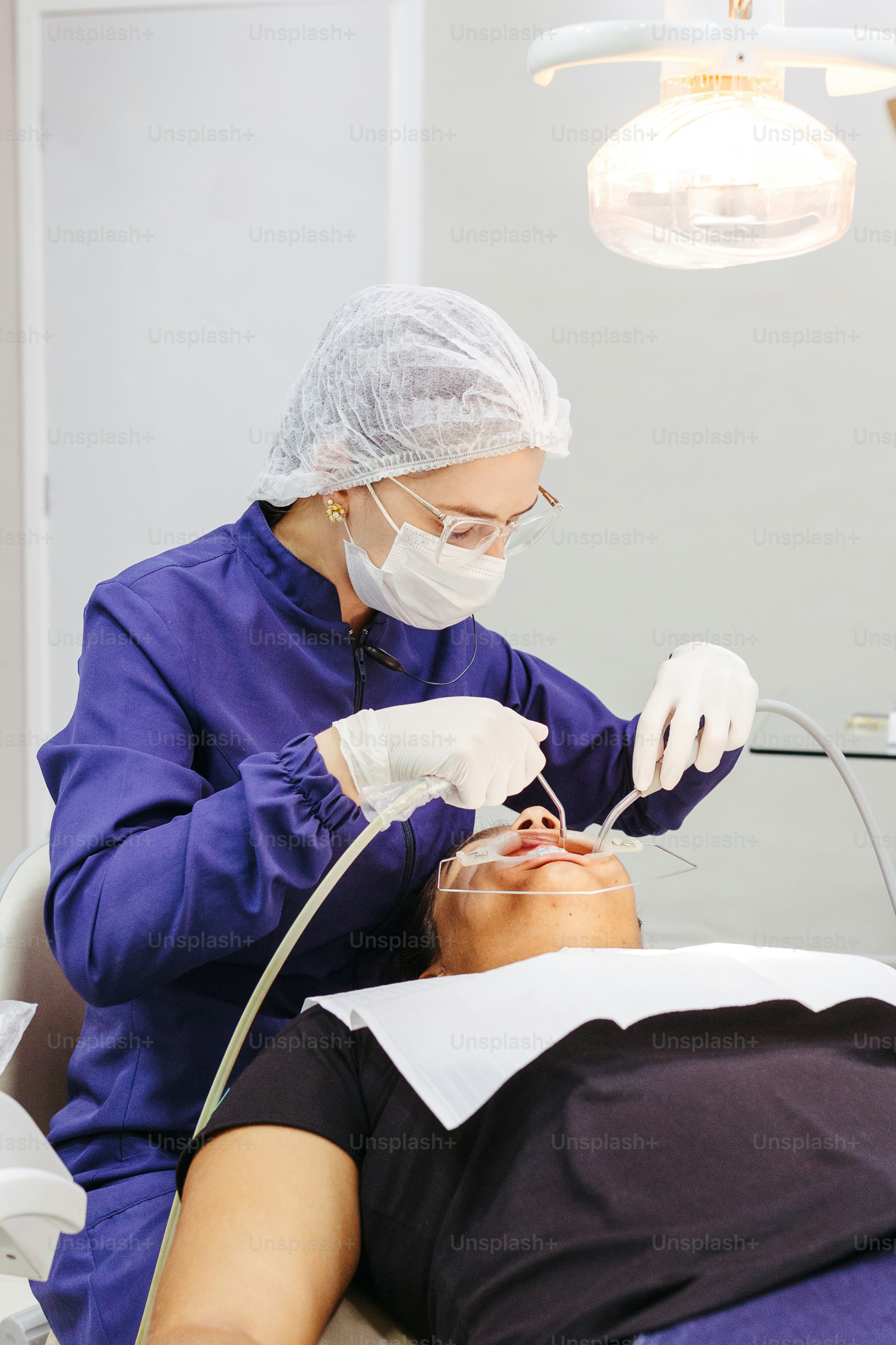 a man getting his teeth checked by a dentist