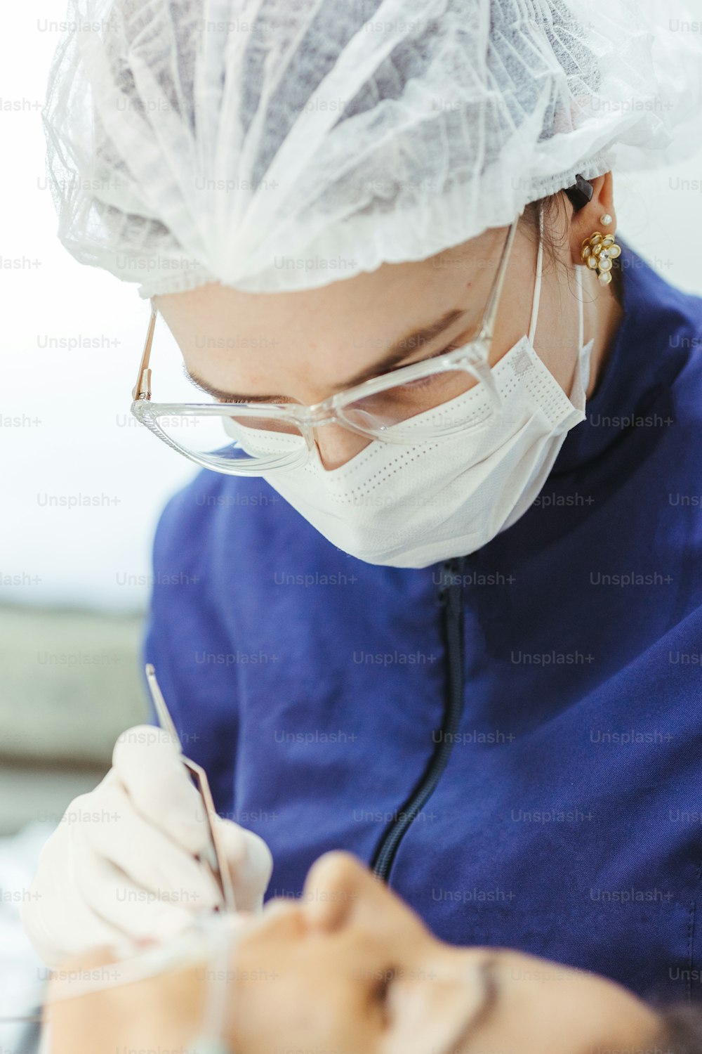 a woman in a surgical mask is doing something