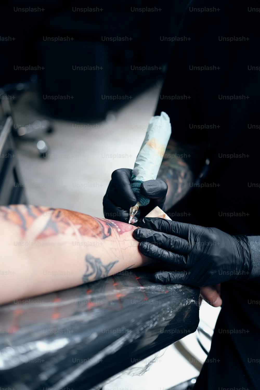 a man getting a tattoo done on his arm