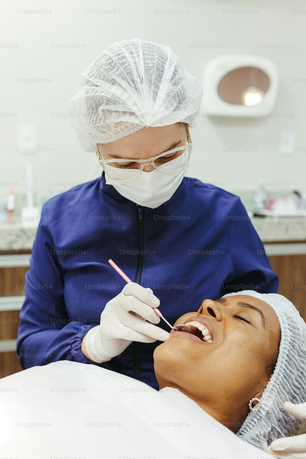 歯科医に歯のチェックを受ける女性