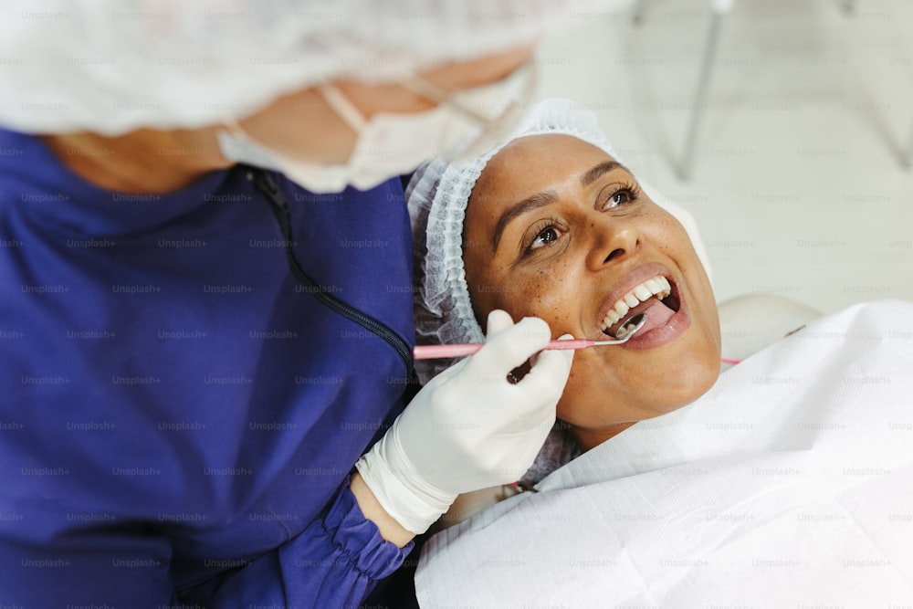 a woman getting her teeth checked by a dentist