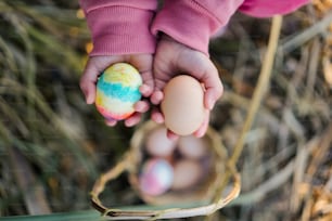a child holding an egg in their hands