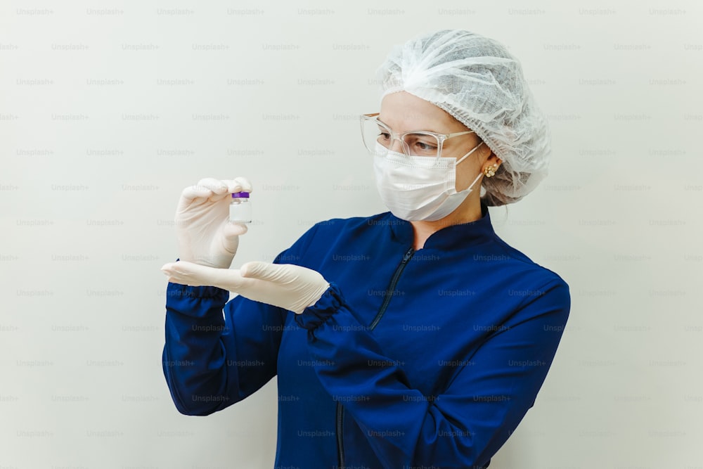 a woman wearing a surgical mask and holding a toothbrush