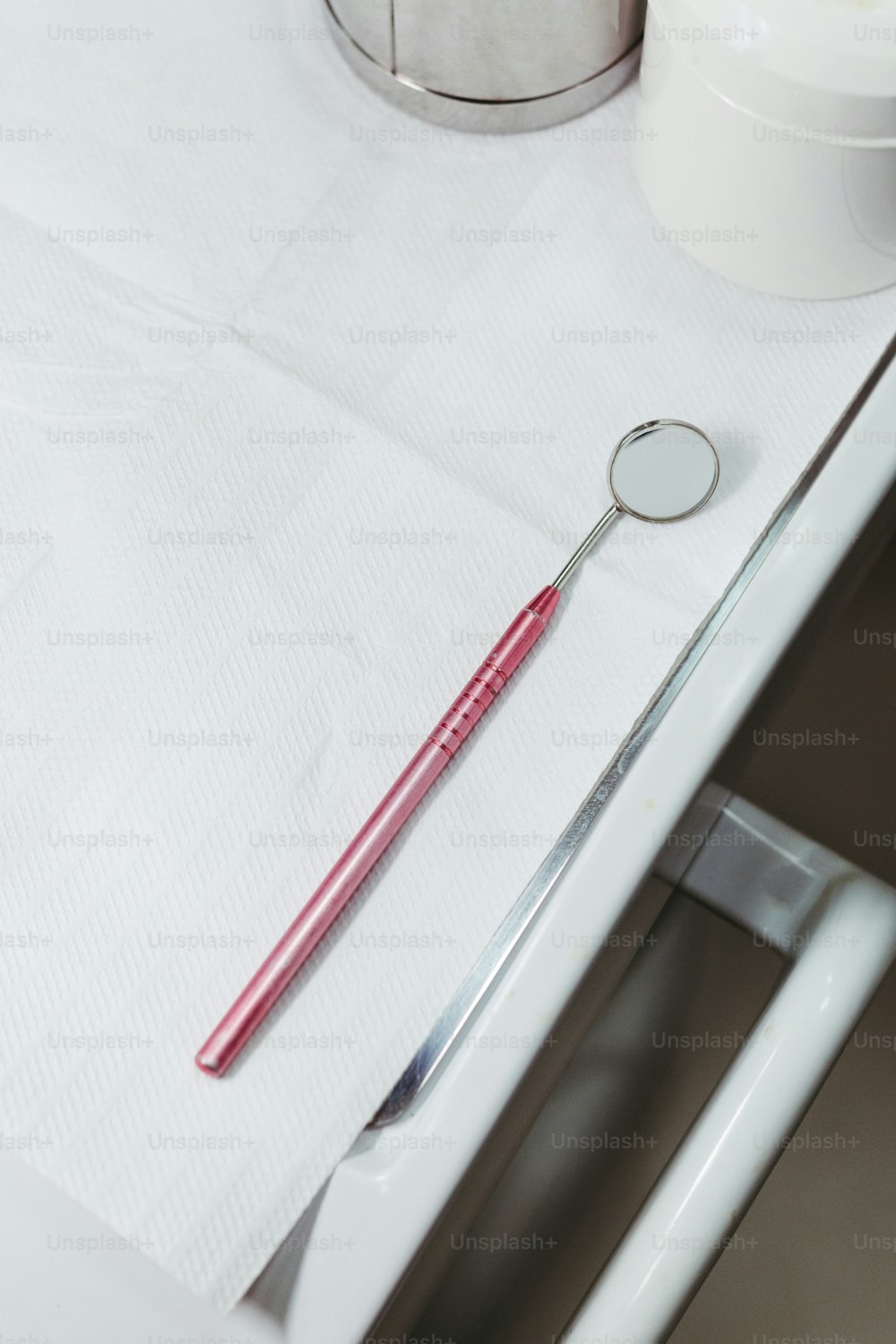 a red toothbrush sitting on top of a white counter