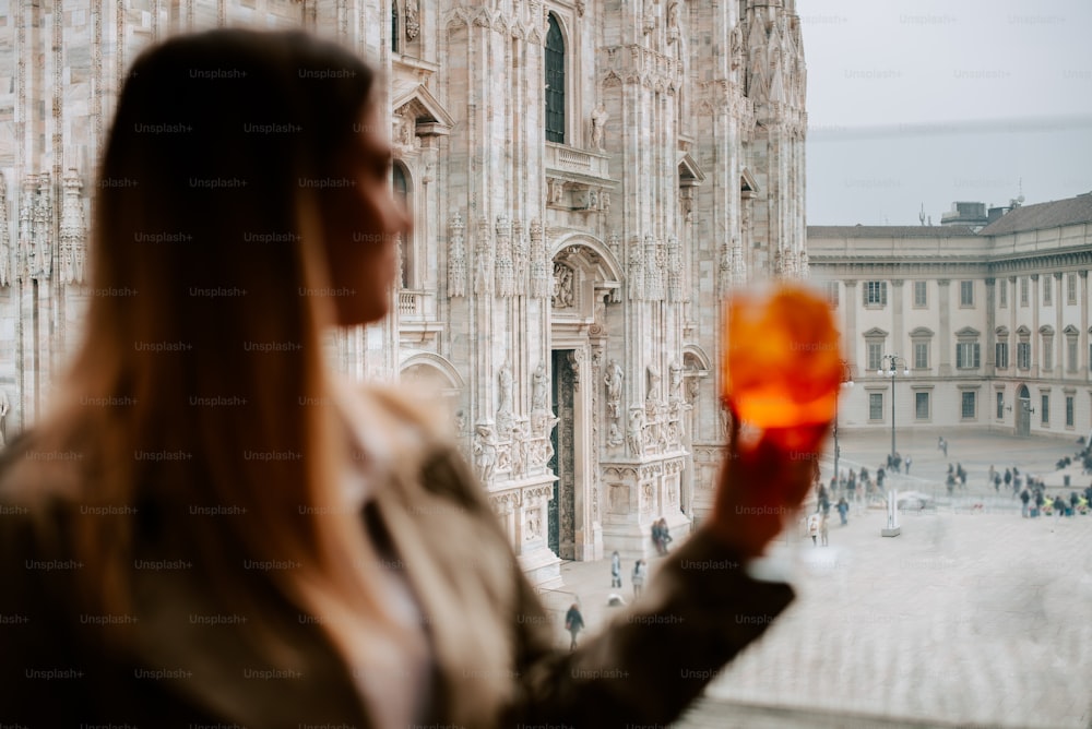 Una mujer mirando por una ventana a una catedral