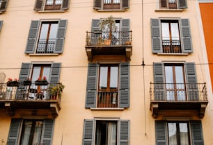 a tall building with lots of windows and balconies