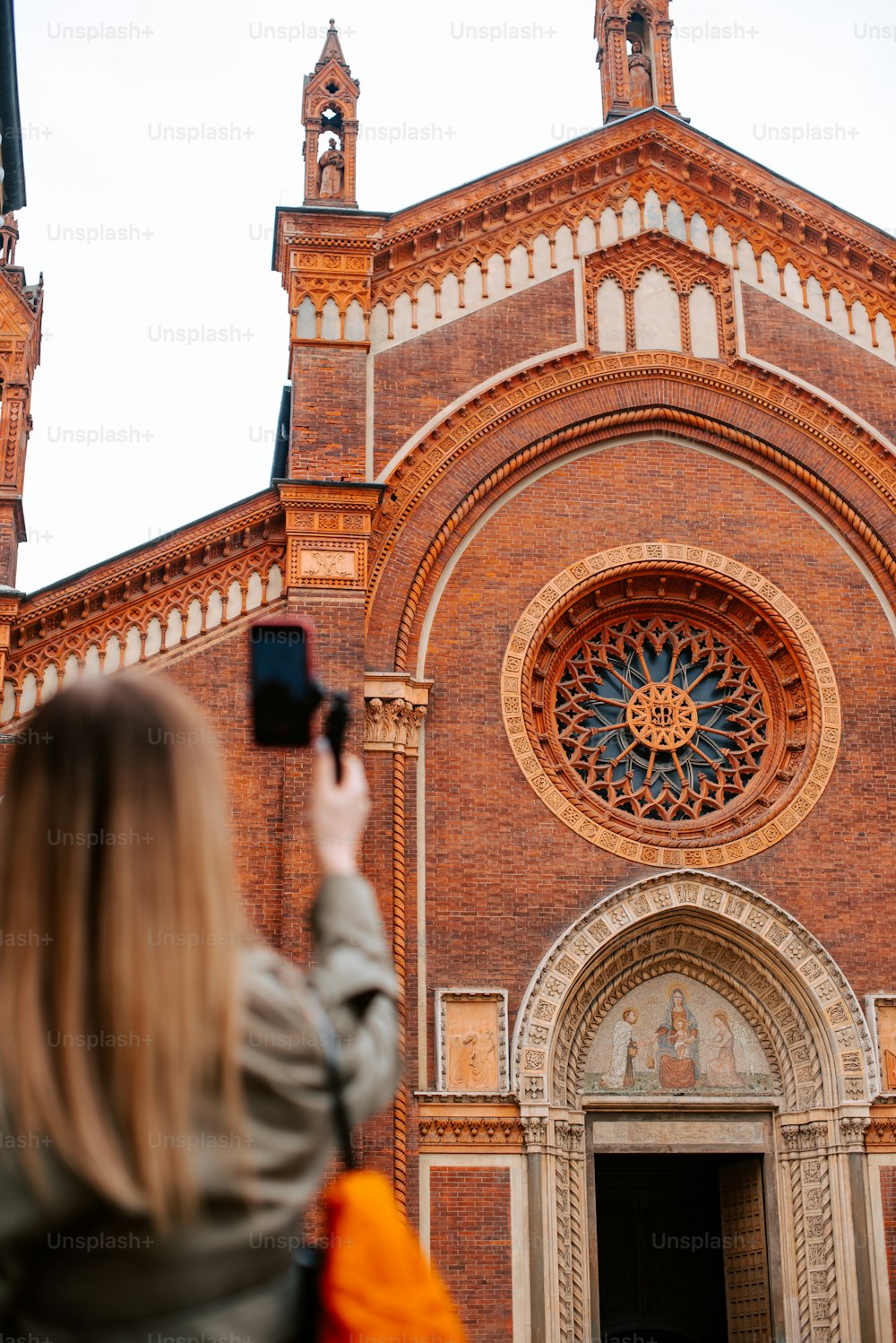 a woman taking a picture of a church