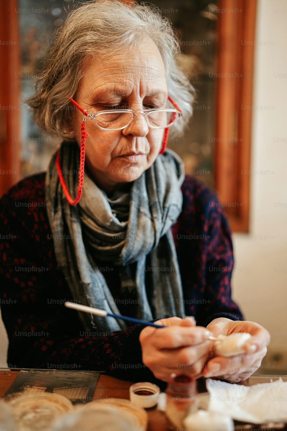 an older woman wearing glasses and a scarf