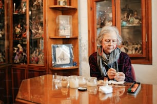 a woman sitting at a table with a cell phone