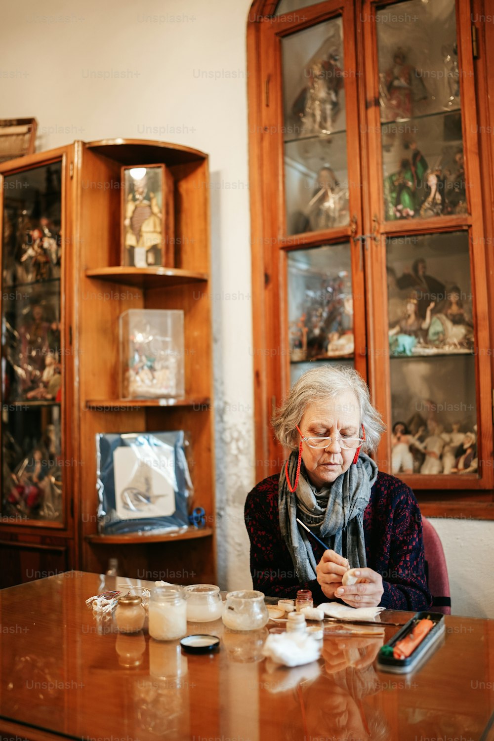 a woman sitting at a table with a cup of coffee