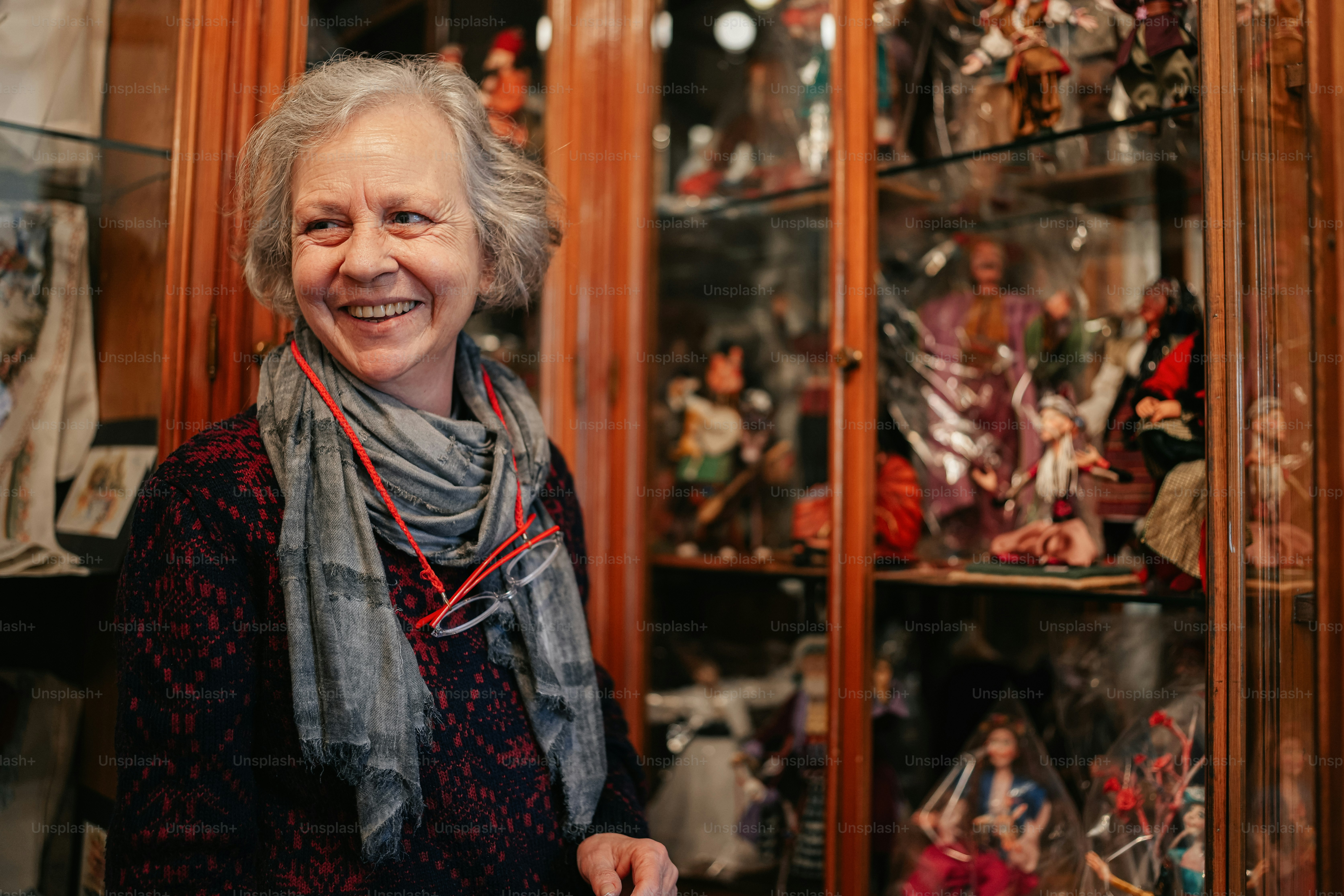 a woman standing in front of a display case filled with figurines