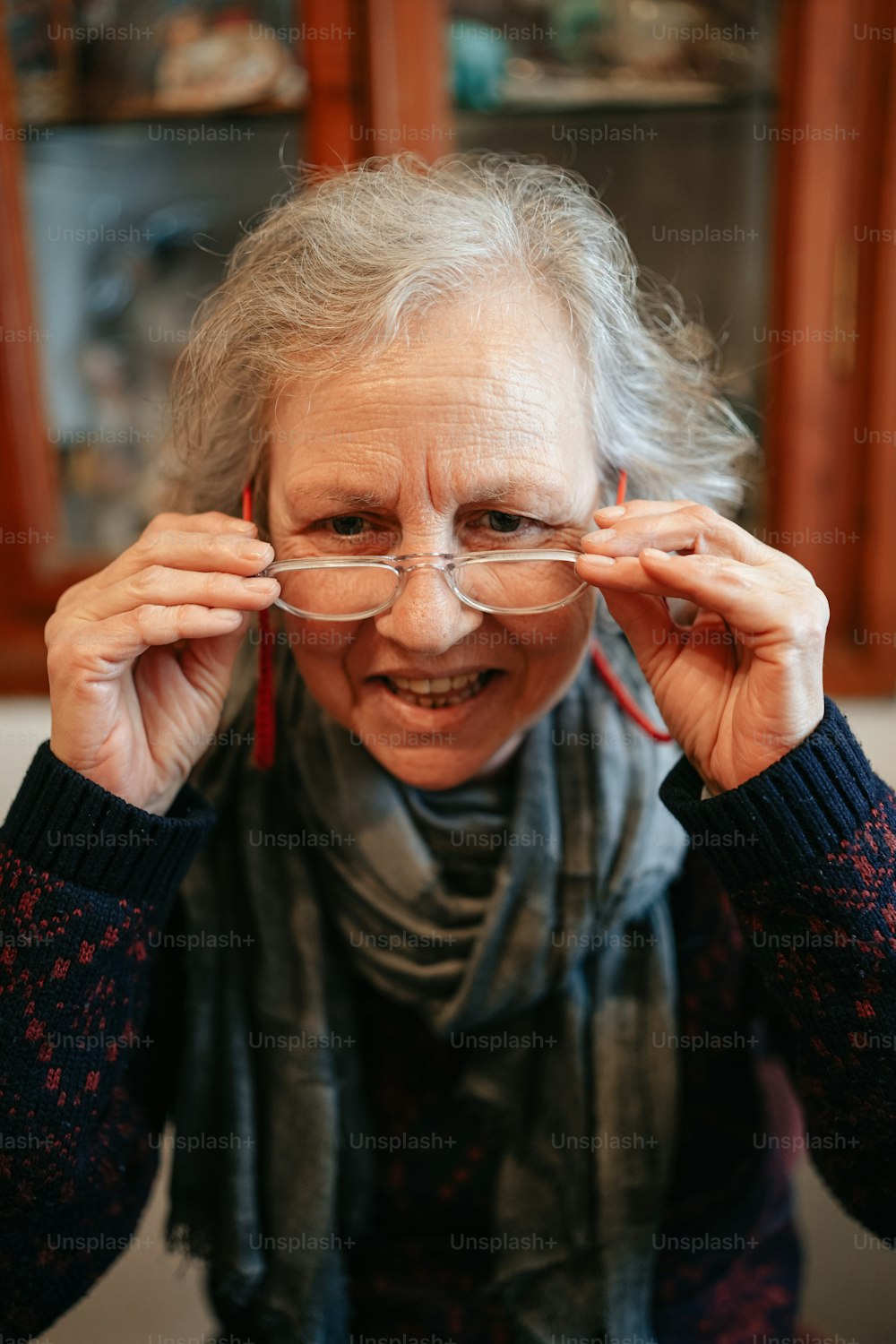 an older woman wearing glasses and a scarf