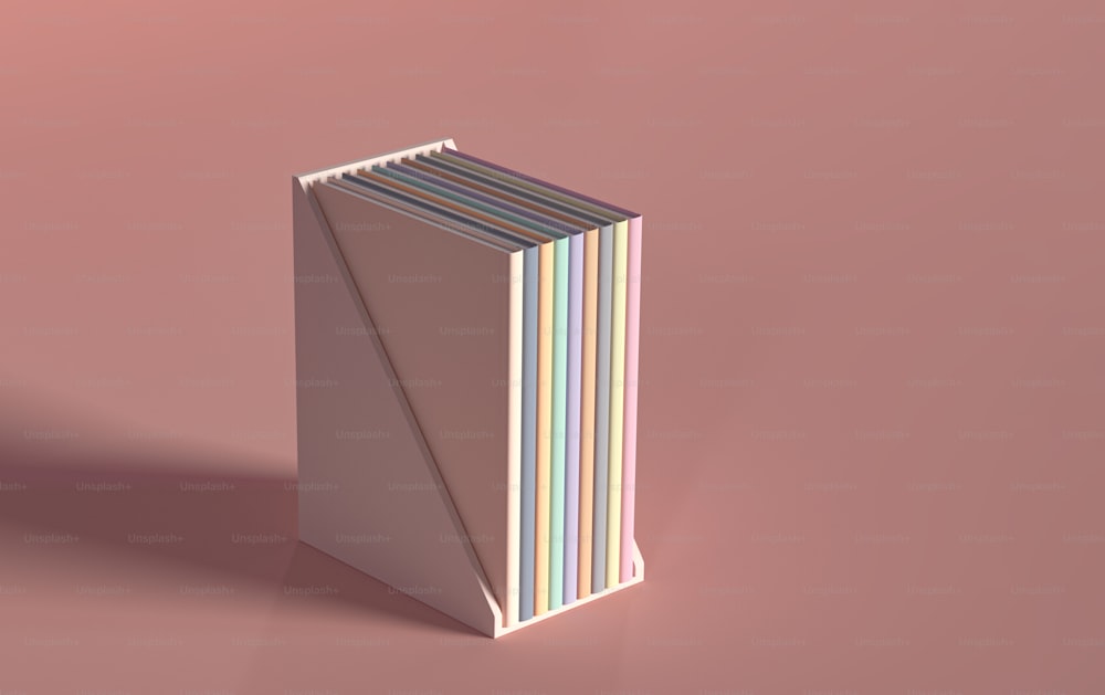 Ein Stapel Bücher sitzt auf einer rosa Oberfläche