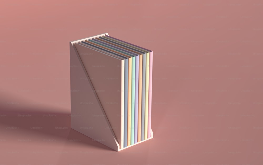 a stack of books sitting on top of a pink surface