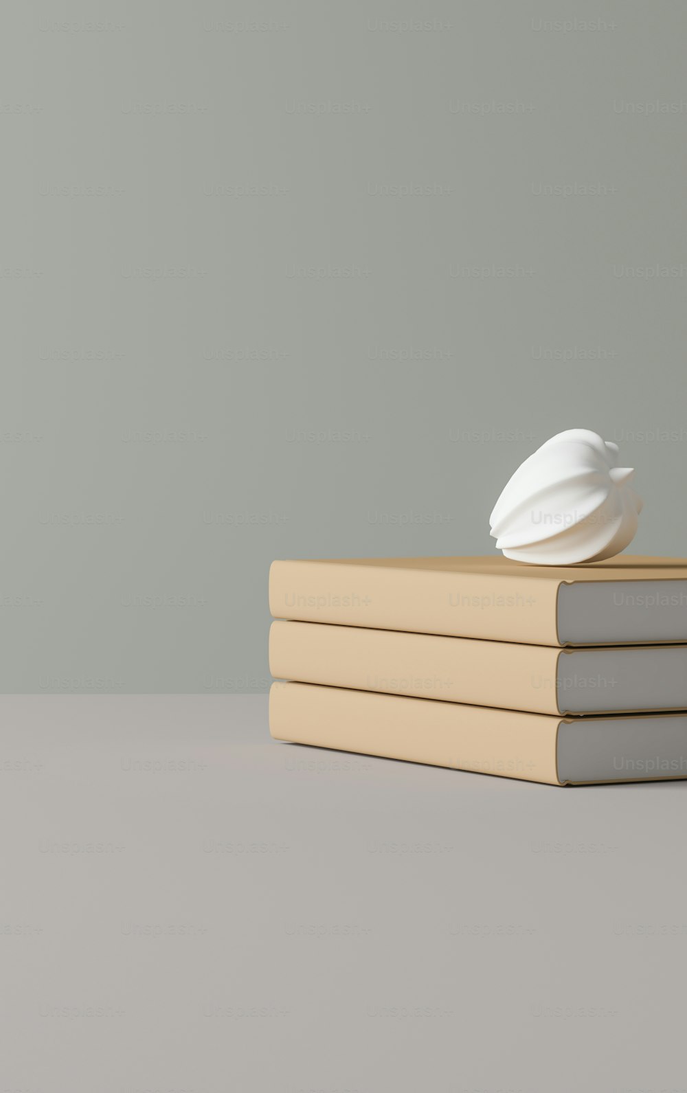 a stack of books with a white object on top of it