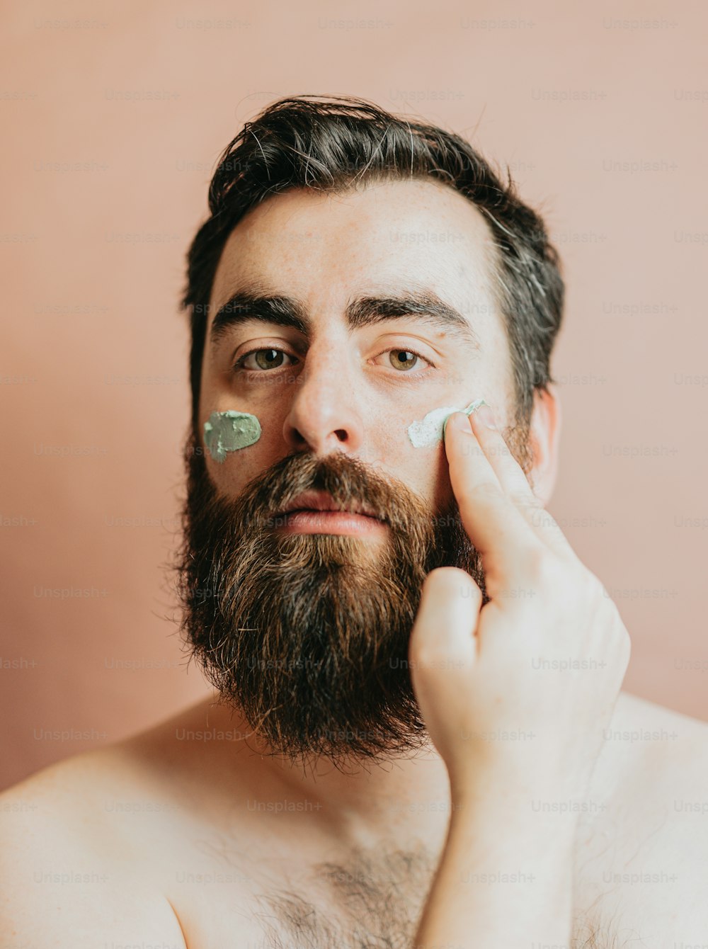 a man is shaving his face with a razor