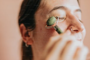 a woman holding a green object to her eye
