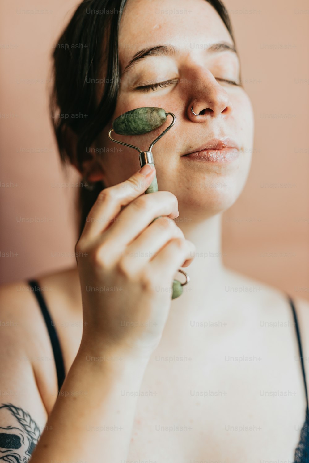 a woman holding a spoon with a leaf on it
