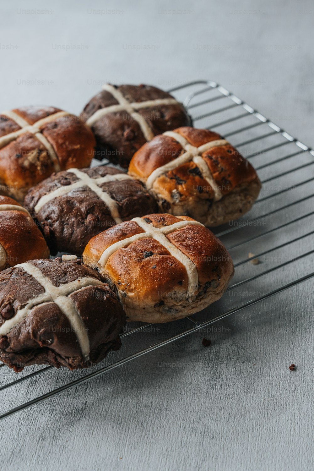 a bunch of hot cross buns sitting on a cooling rack