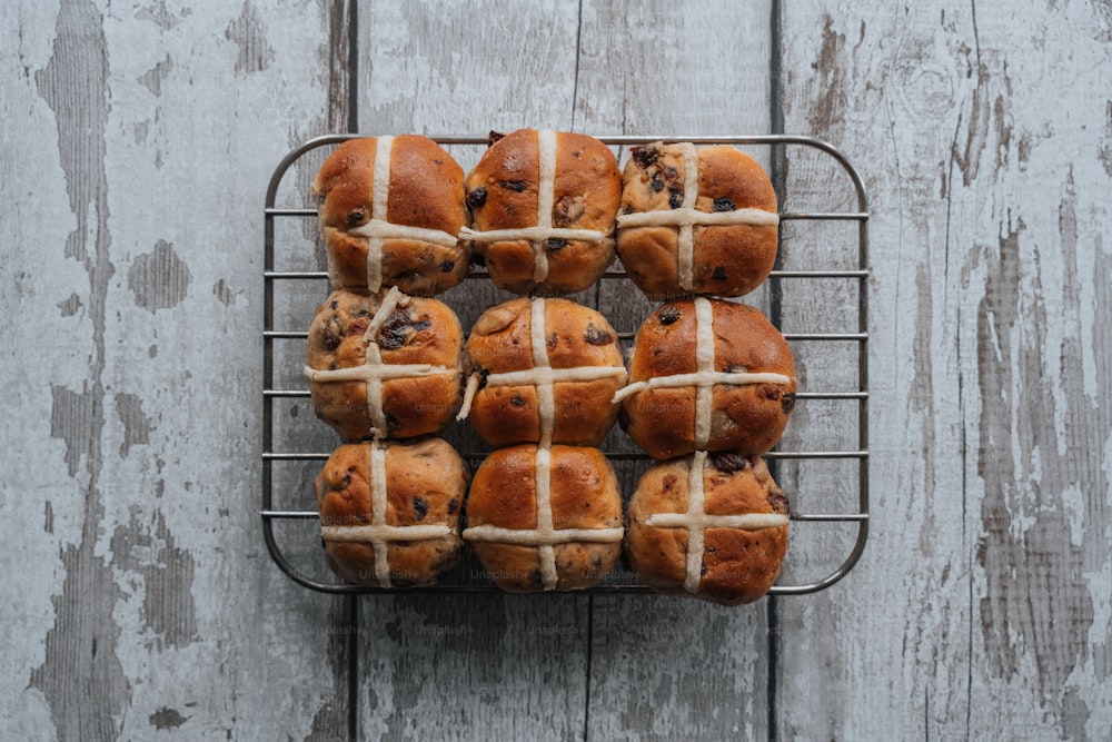 a bunch of hot cross buns on a wire rack