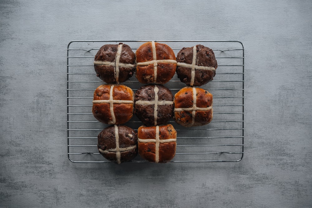 a bunch of hot cross buns on a cooling rack