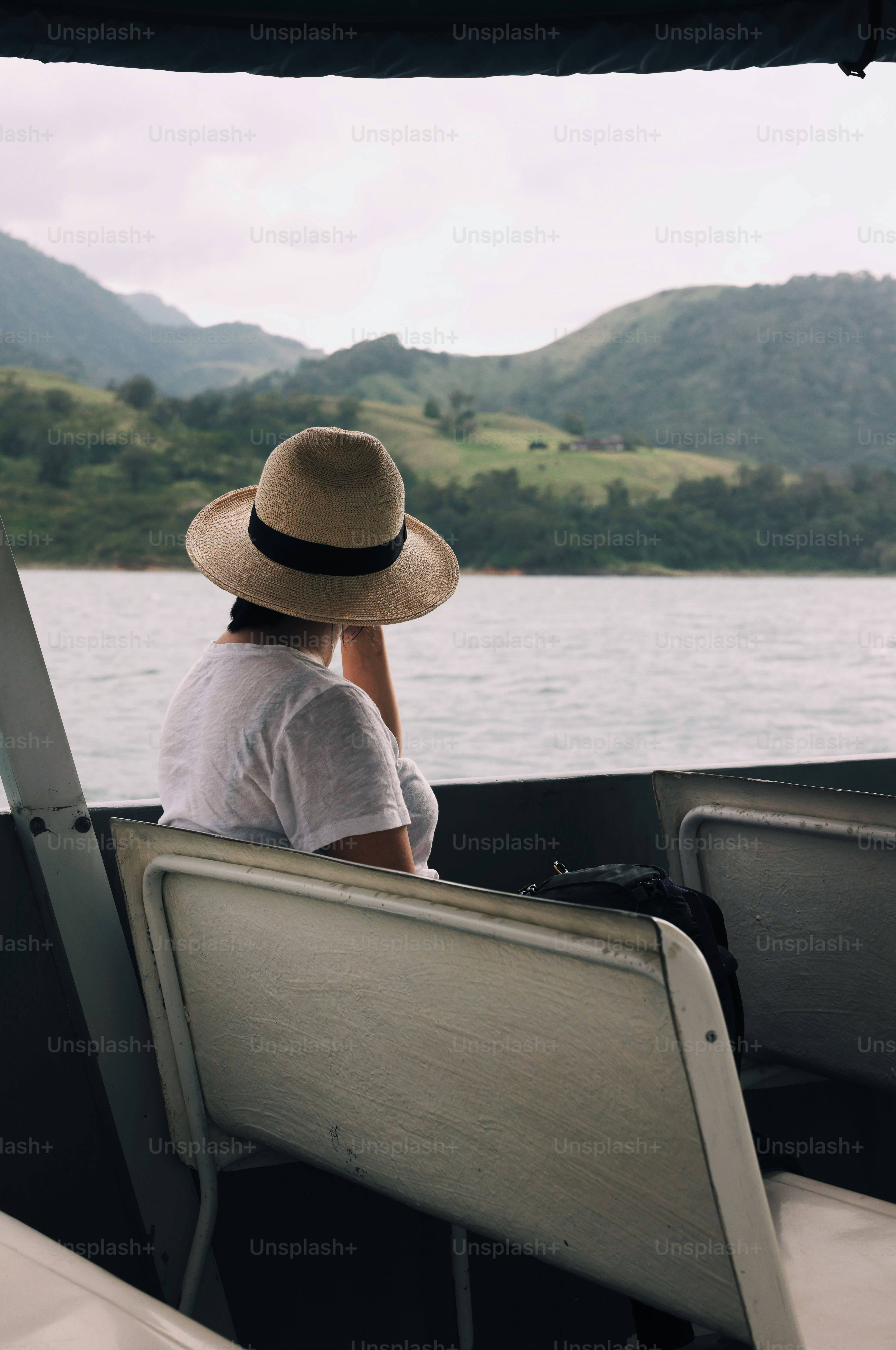 A man and woman sitting on a boat in the water photo – Travel Image on ...