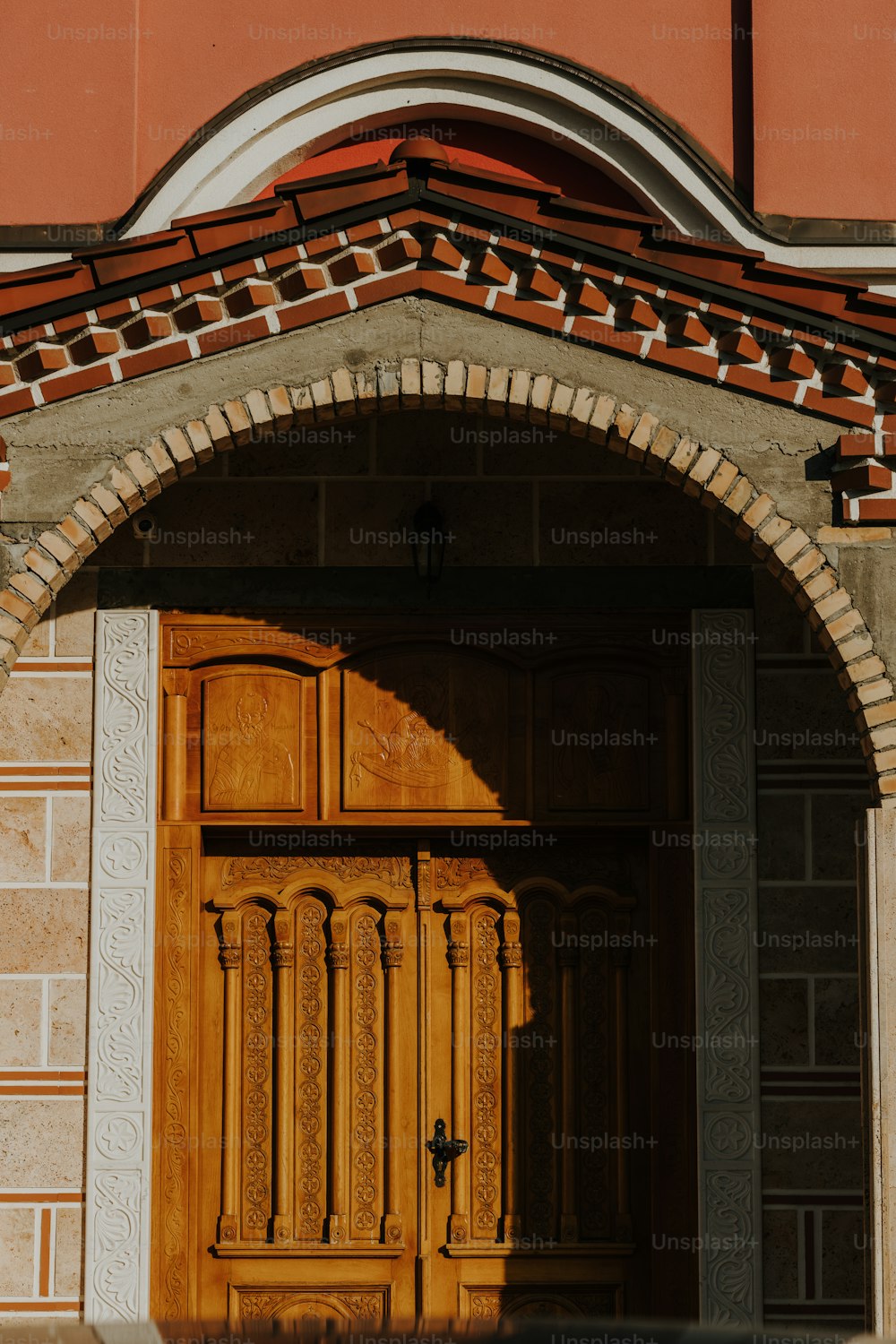 a wooden door with a brick arch above it