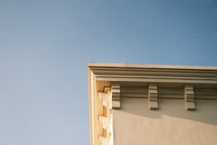 the corner of a building with a sky background