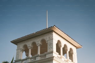 a tall white building with a flag on top of it