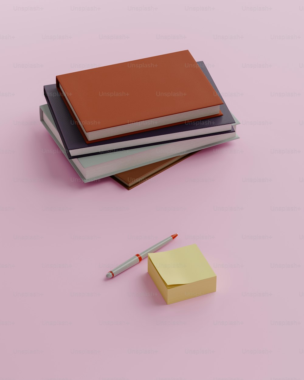 una pila di libri e una penna su una superficie rosa