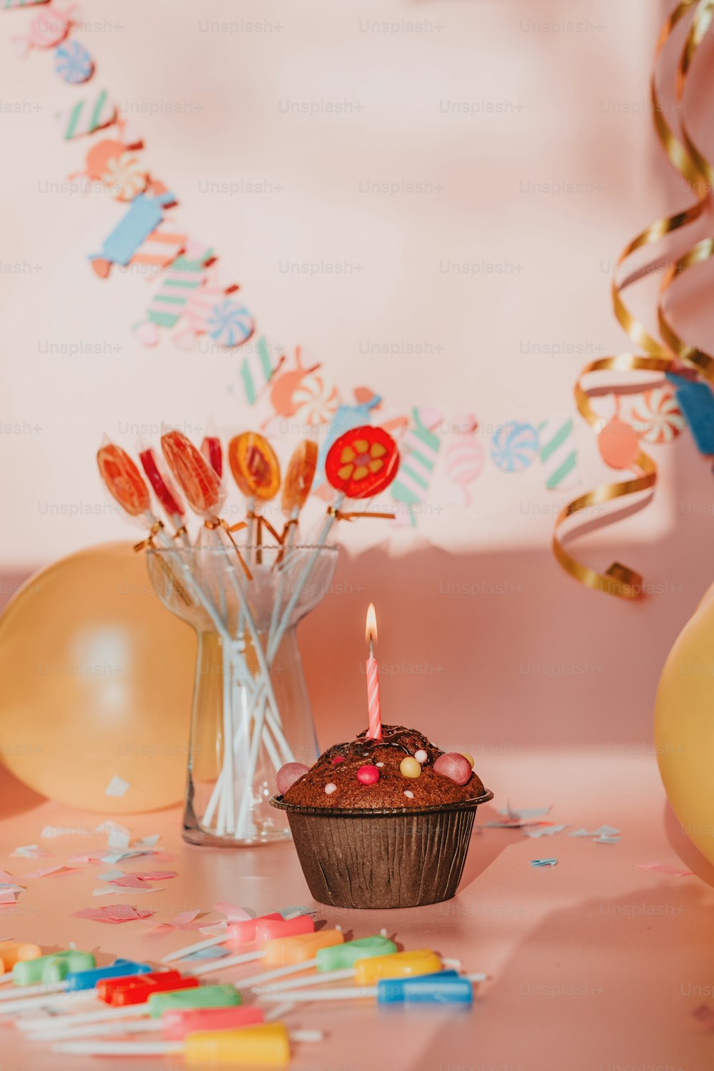 a cupcake with a lit candle on a table