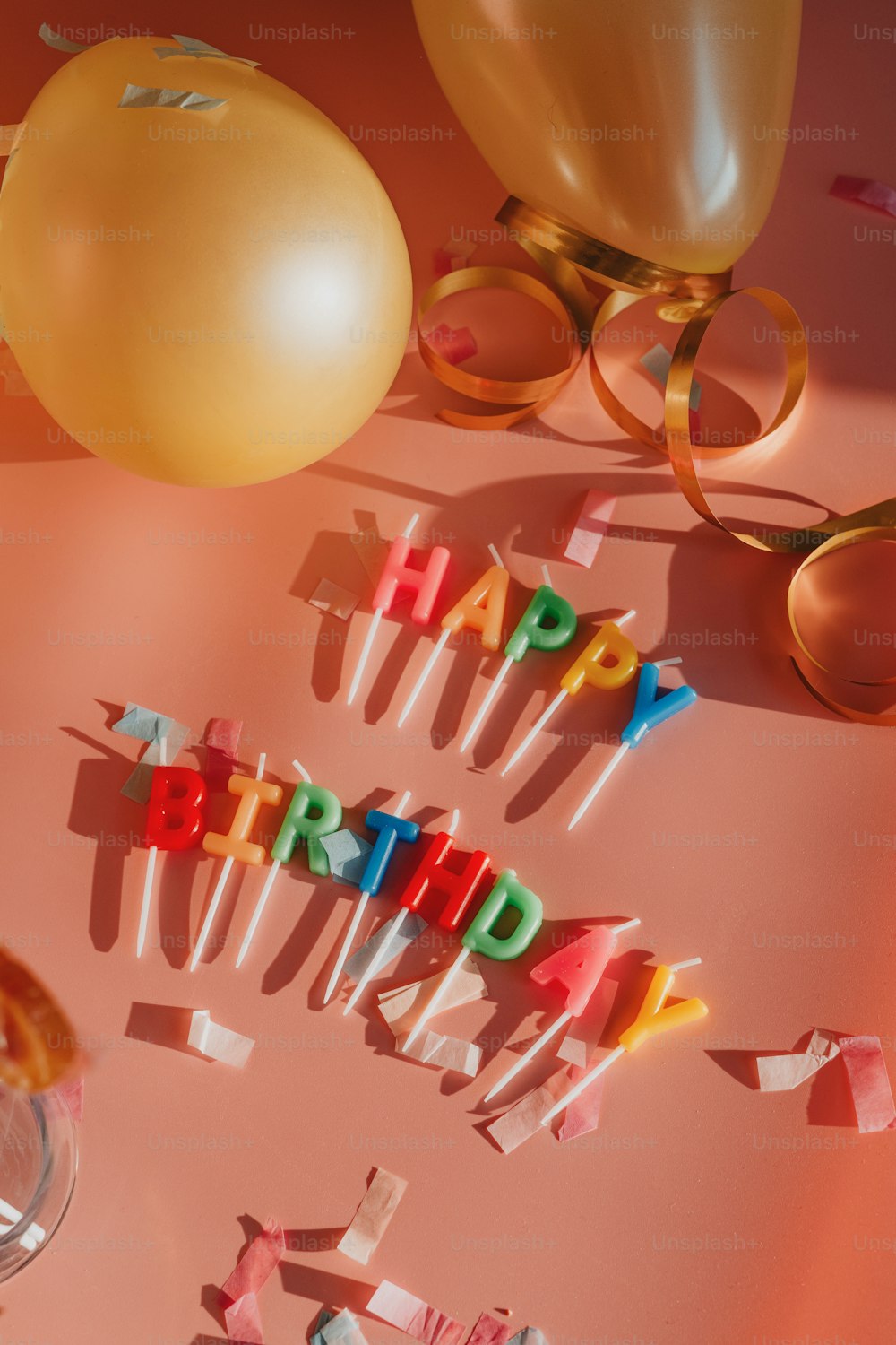 a table topped with lots of candles and balloons