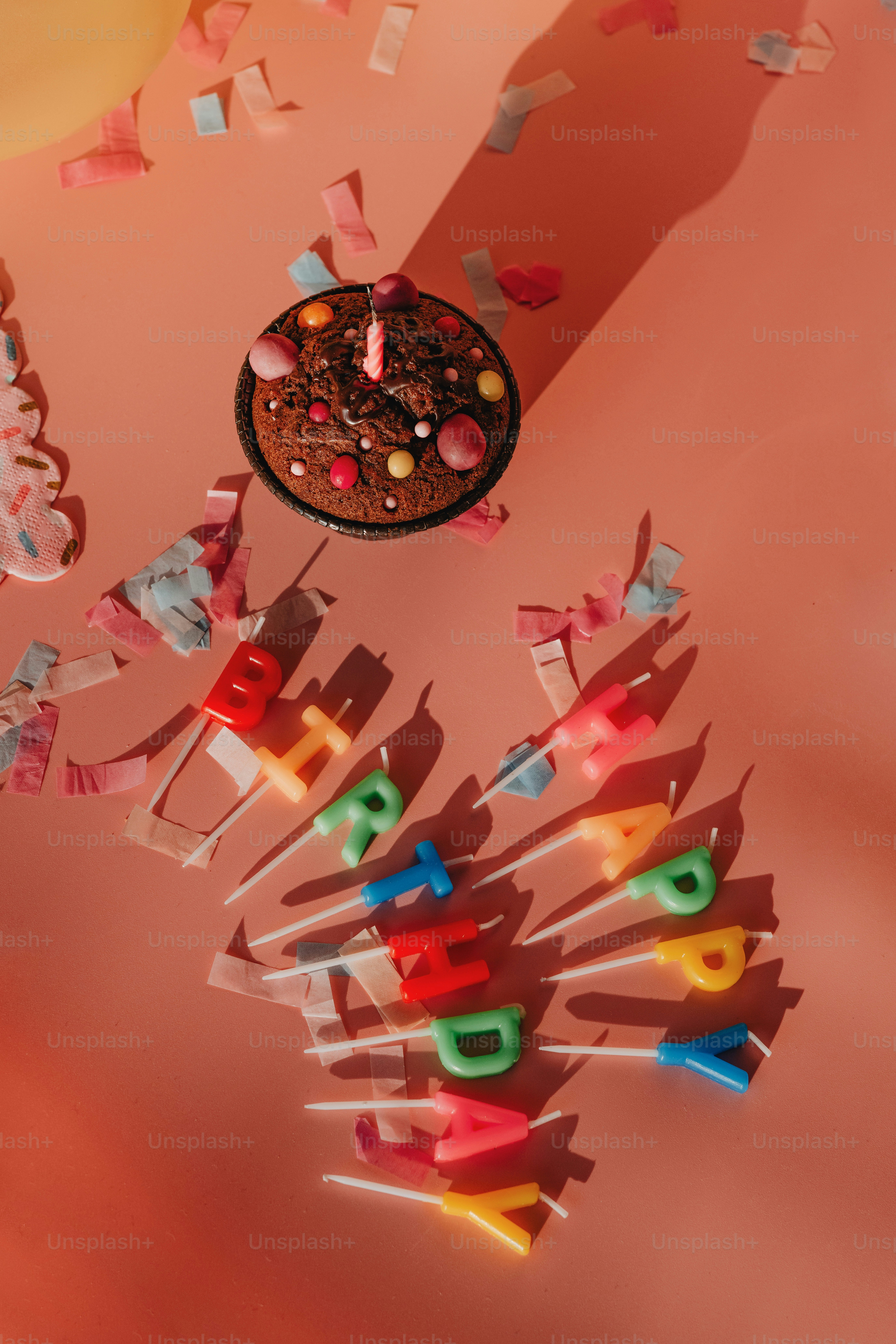 a birthday cake surrounded by candles and streamers