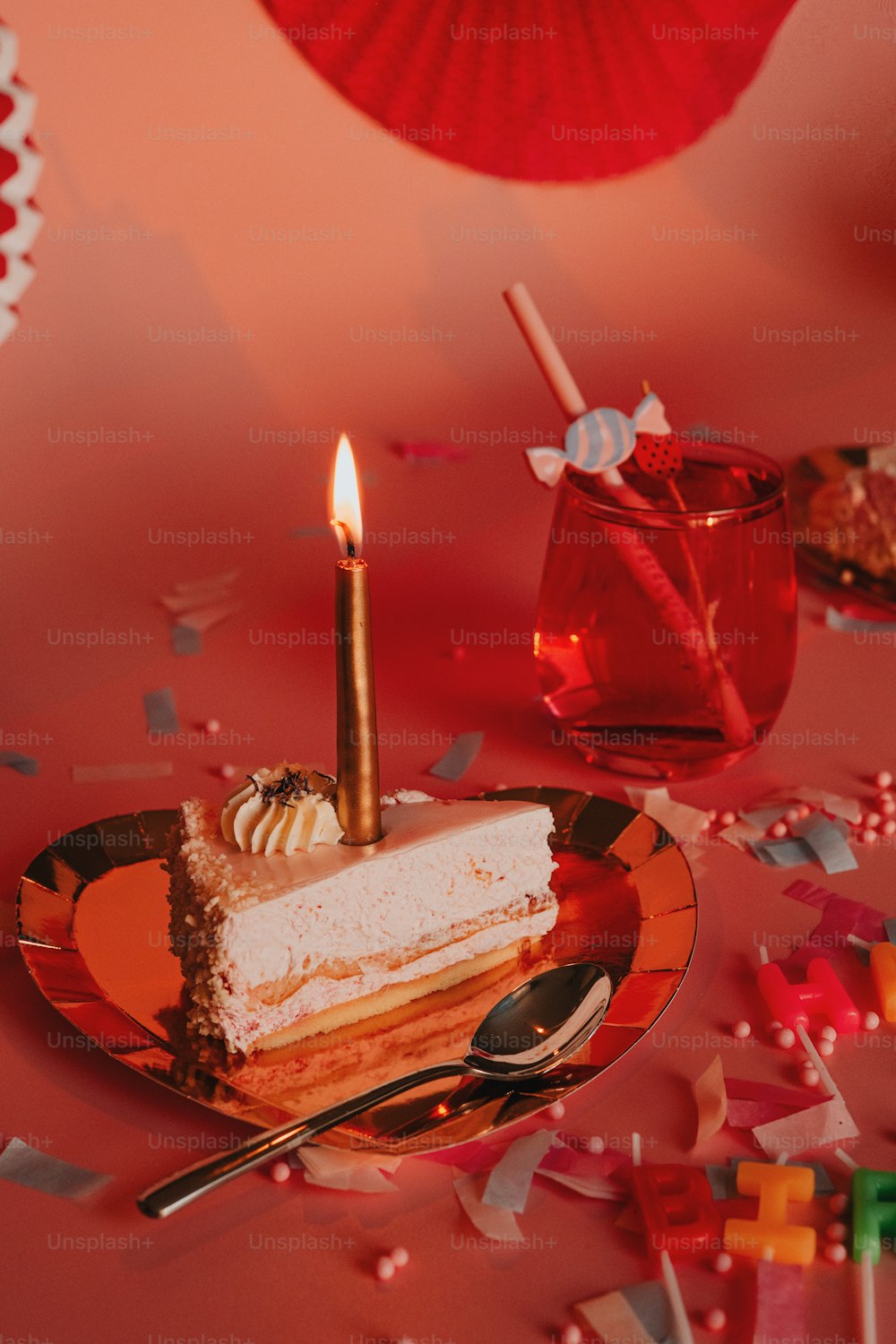 a piece of cake on a plate with a candle