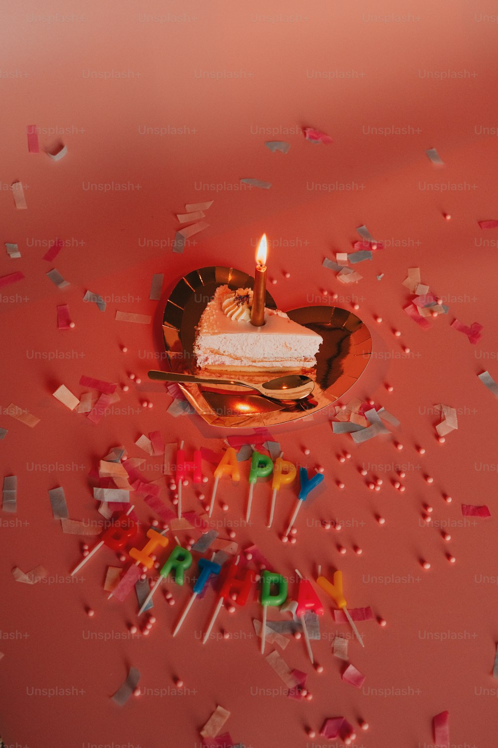 a birthday cake with a lit candle on top of it