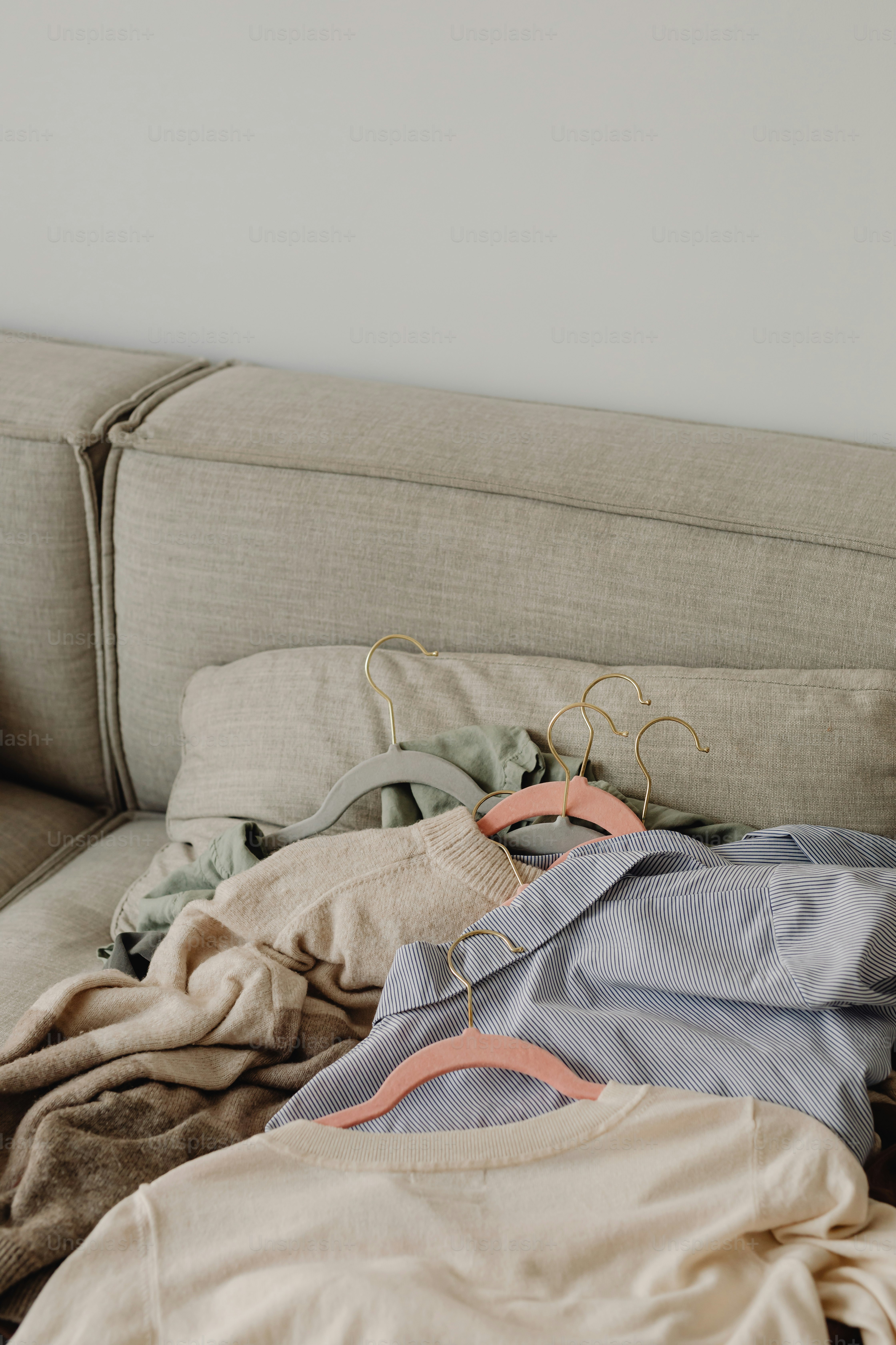 a pile of clothes sitting on top of a couch